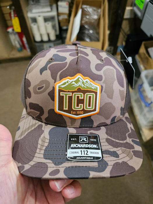 TCO Fly Shop Hat Crest Logo - Printed 5 Panel Trucker Admiral Duck Camo - Black