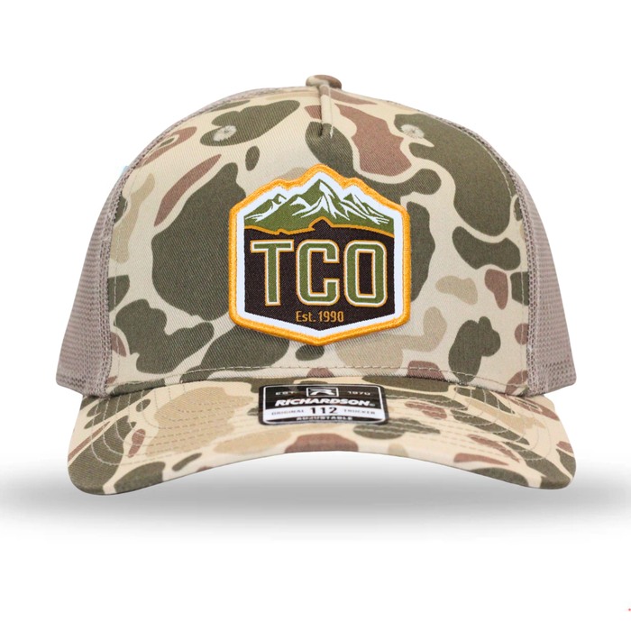 Camouflage trucker hat with TCO logo on a white background